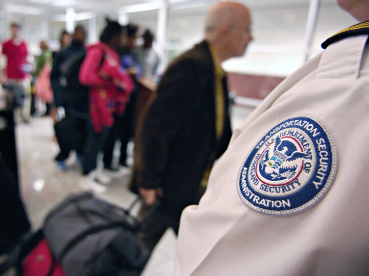 A TSA employee screens travelers at Hartsfield-Jackson International Airport in Atlanta, Ga., November 2007. TSA is expecting to screen 20 million travelers this Thanksgiving season.