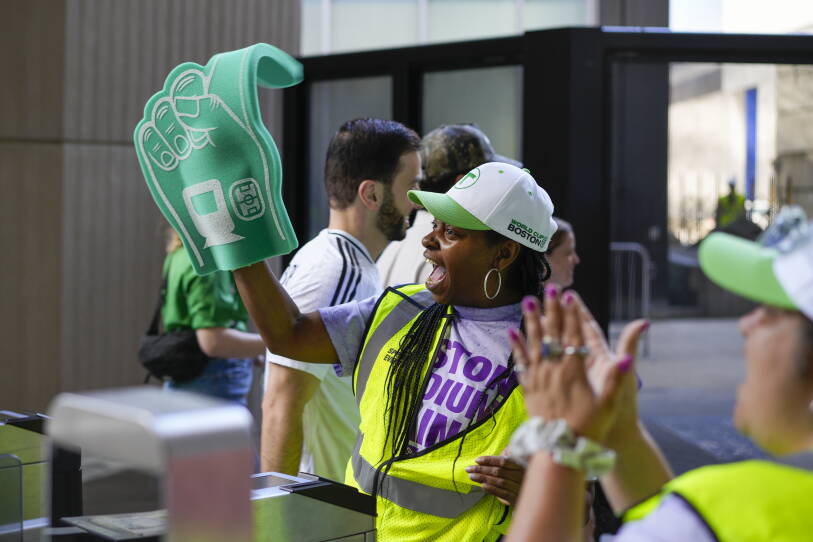 A person with a foam finger cheers at South Station.
