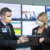 Dr. Michael Maniaci and Dr. Margaret Paulson confer at the Mayo Clinic's hospital-at-home command center in Jacksonville, Florida.