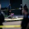 A person places flowers outside the scene of the mass shooting at a supermarket in Buffalo, N.Y., on Sunday.