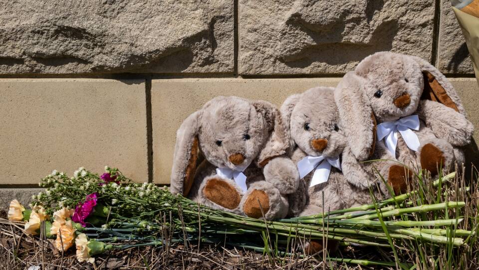 Items are left at a makeshift memorial at the entrance of the Covenant School after the mass shooting.
