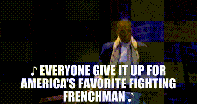A man sings "everyone give it up for America's favorite fighting Frenchman!"