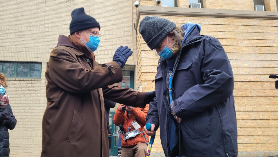 Cardinal Sean O'Malley blesses Pine Street Inn resident Patrick Hogan on Christmas Eve 2021 before the homeless shelter's annual holiday luncheon.