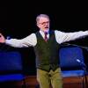 Brian O'Donovan pictured on stage during  a production of  "A St. Patrick's Day Celtic Sojourn,"  March 16, 2019. He's greeting the audience, with his arms outstretched.