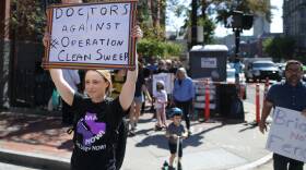 Protesters march down Massachusetts Avenue in Boston in opposition of Operation Clean Sweep
