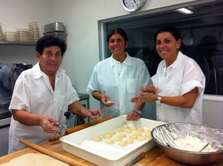 The Pallotta sisters cooking pasta with their mom.