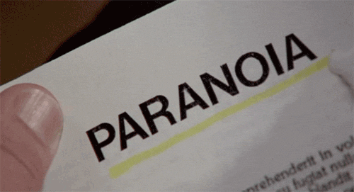 A hand underlines the word paranoia