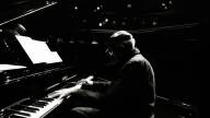 Abdullah Ibrahim plays a grand piano in a concert hall