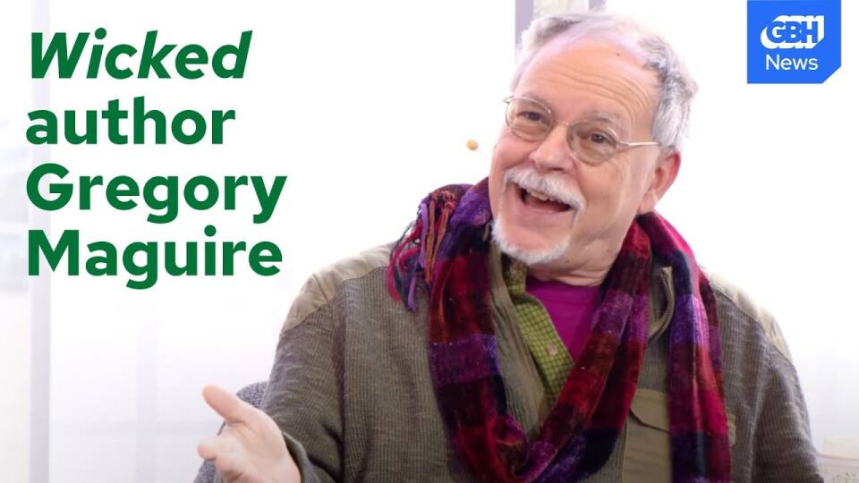 A man in a scarf and glasses with the words "Wicked author Gregory Maguire" superimposed over his shoulder.