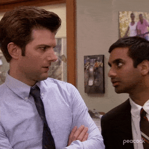 A man leans into a colleague's space and says "suspicious!"