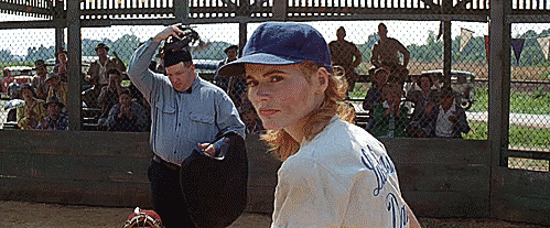 A woman swings a baseball bat.