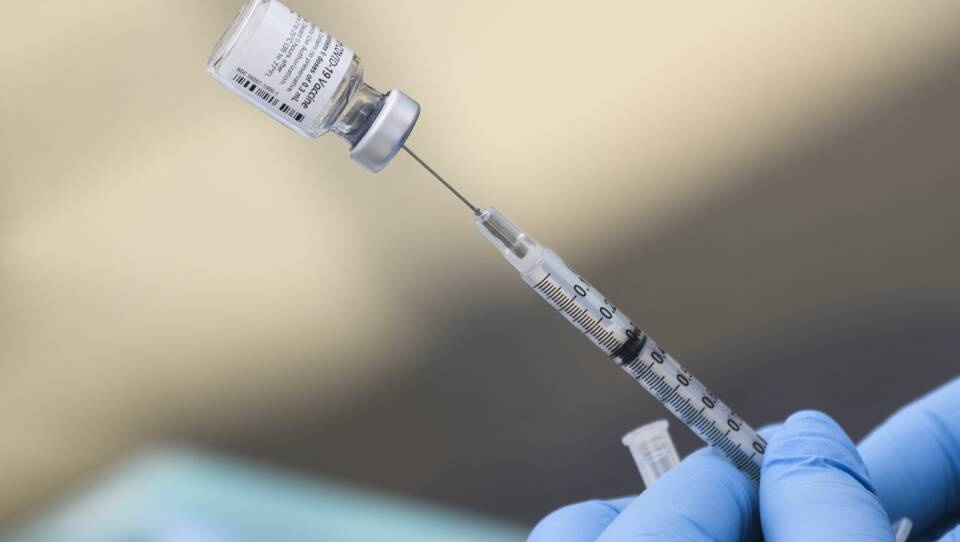 A syringe is filled with a dose of the Pfizer-BioNTech COVID-19 vaccine. While the vaccine has now been authorized for children between ages 5 and 11, it may take several weeks for shots to become widely available.